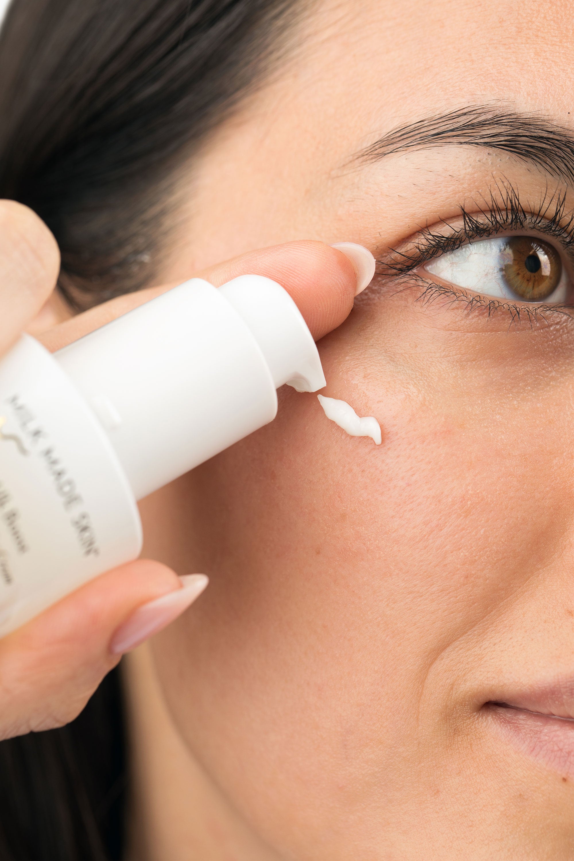 woman using Milk Made Skin Milk Boost eye Cream